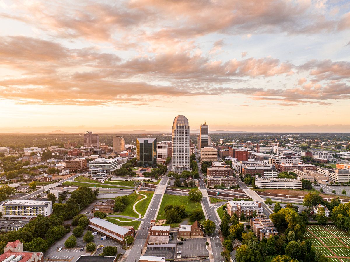 Old Salem Museums & Gardens Aerial Shot with Downtown Winston-Salem, NC